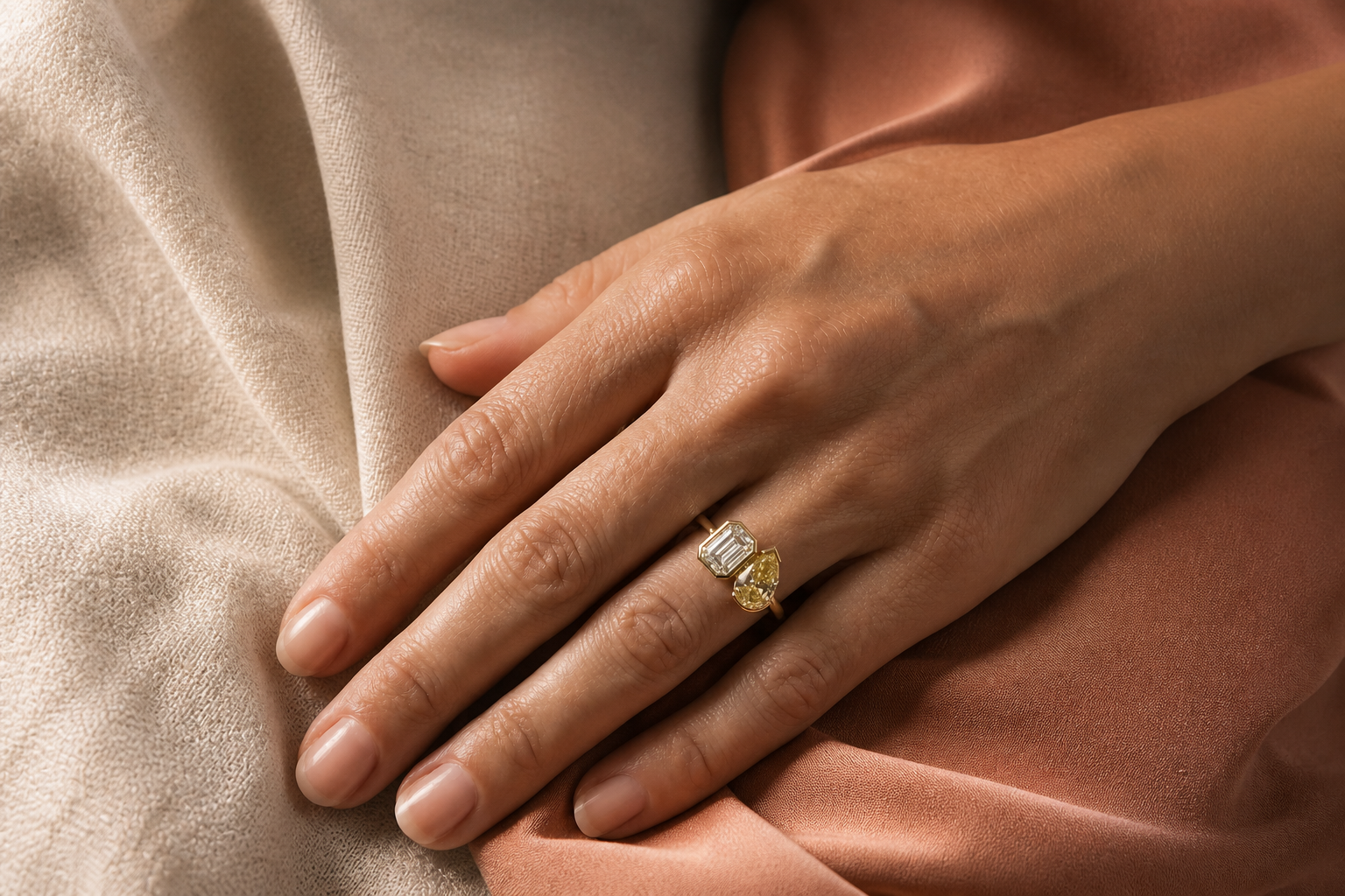 Lia Fáil diagonal emerald cut and yellow pear cut diamond ring styled alone on the hand